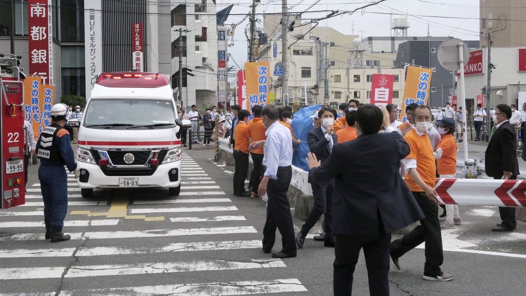 People react after gunshots in Nara, western Japan Friday, July 8, 2022. Japan’s former Prime Minister Shinzo Abe was in heart failure after apparently being shot during a campaign speech Friday in western Japan, NHK public television said Friday. (Kyodo News via AP) TKMY806