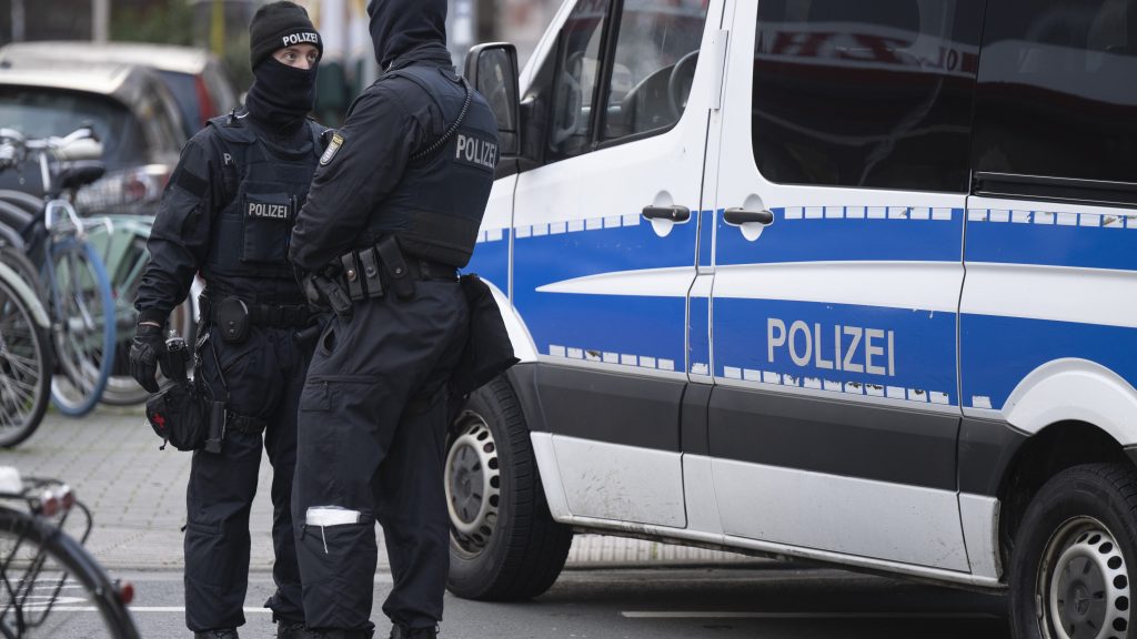 Police officers stand by a searched property in Frankfurt during a raid against so-called 'Reich citizens' in Frankfurt, Germany, Wednesday, Dec. 7, 2022. Thousands of police carried out a series of raids across much of Germany on Wednesday against suspected far-right extremists who allegedly sought to overthrow the state by force. Federal prosecutors said some 3,000 officers conducted searches at 130 sites in 11 of Germany's 16 states against adherents of the so-called Reich Citizens movement. Some members of the grouping reject Germany's postwar constitution and have called for the overthrow of the government. (Boris Roessler/dpa via AP) DSOB101