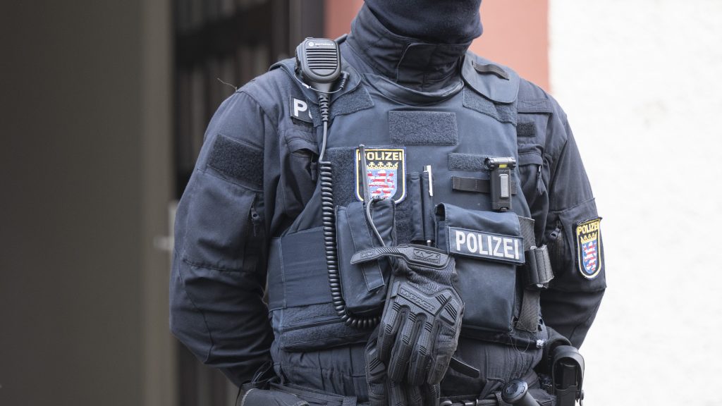 Police officers stand by a searched property in Frankfurt during a raid against so-called 'Reich citizens' in Frankfurt, Germany, Wednesday, Dec. 7, 2022. Thousands of police carried out a series of raids across much of Germany on Wednesday against suspected far-right extremists who allegedly sought to overthrow the state by force. Federal prosecutors said some 3,000 officers conducted searches at 130 sites in 11 of Germany's 16 states against adherents of the so-called Reich Citizens movement. Some members of the grouping reject Germany's postwar constitution and have called for the overthrow of the government. (Boris Roessler/dpa via AP) DSOB102