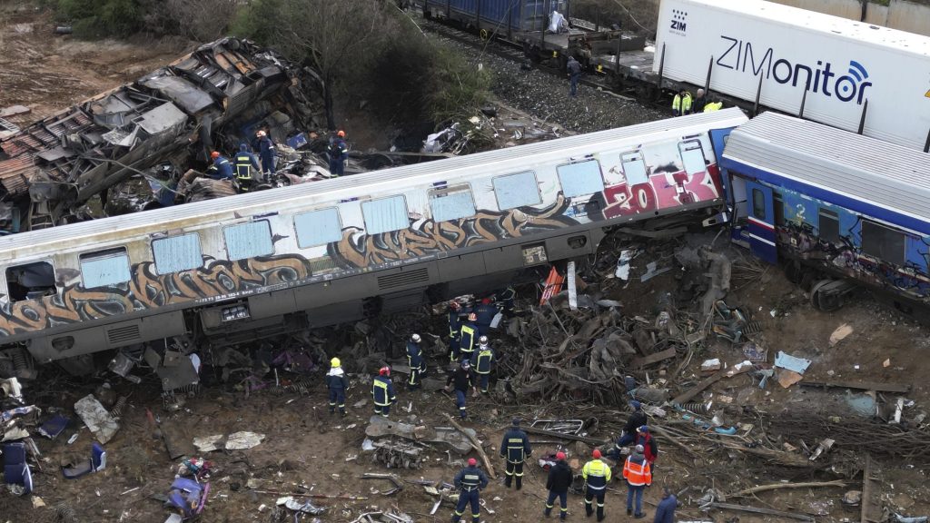 Firefighters and rescuers operate after a collision in Tempe near Larissa city, Greece, Wednesday, March 1, 2023. A train carrying hundreds of passengers has collided with an oncoming freight train in northern Greece, killing and injuring dozens passengers. (AP Photo/Vaggelis Kousioras) XTS121