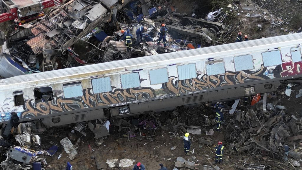 Firefighters and rescuers operate after a collision in Tempe near Larissa city, Greece, Wednesday, March 1, 2023. A train carrying hundreds of passengers has collided with an oncoming freight train in northern Greece, killing and injuring dozens passengers. (AP Photo/Vaggelis Kousioras) XTS120