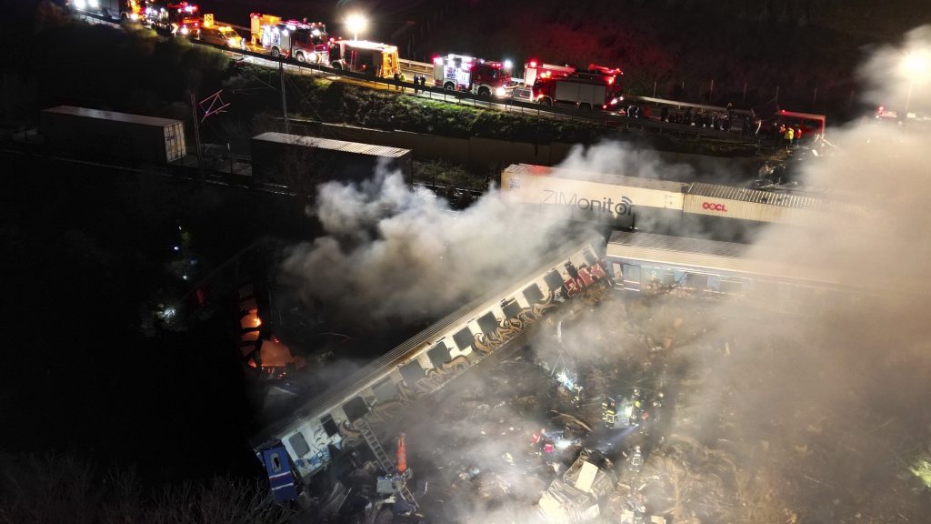 Smoke rises from trains as firefighters and rescuers operate after a collision near Larissa city, Greece, early Wednesday, March 1, 2023. The collision between a freight and passenger train occurred near Tempe, some 380 kilometers (235 miles) north of Athens, and resulted in the derailment of several train cars. (AP Photo/Vaggelis Kousioras) XTS103
