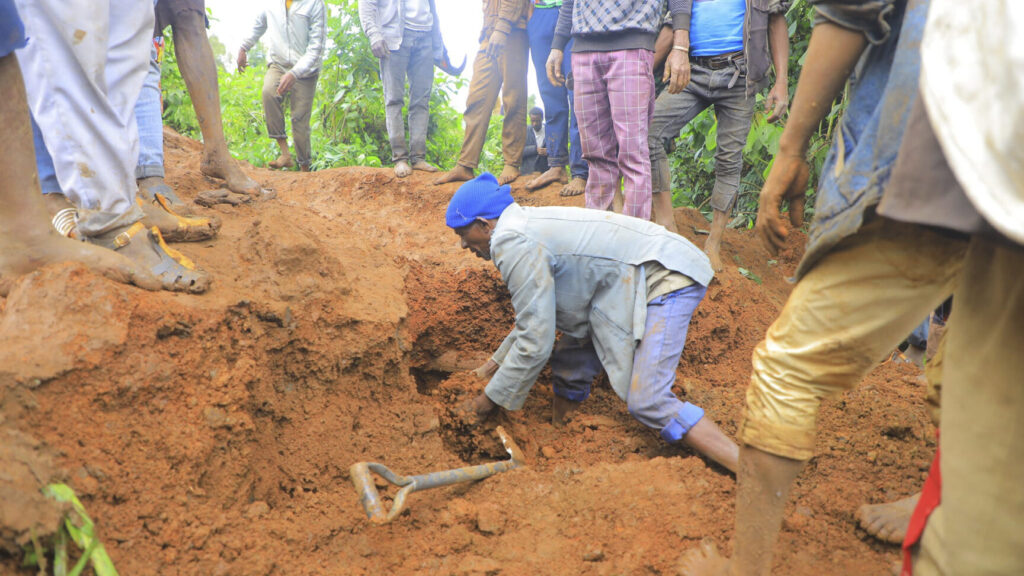 ADDS NAME OF THE PHOTOGRAPHER - In this handout photo released by Gofa Zone Government Communication Affairs Department, a man searches for survivors hundreds of people gather at the site of a mudslide in the Kencho Shacha Gozdi district, Gofa Zone, southern Ethiopia, Monday, July 22, 2024. At least 146 people were killed in mudslides in a remote part of Ethiopia that has been hit with heavy rainfall, according to local authorities. (Isayas Churga/Gofa Zone Government Communication Affairs Department via AP) XTM103