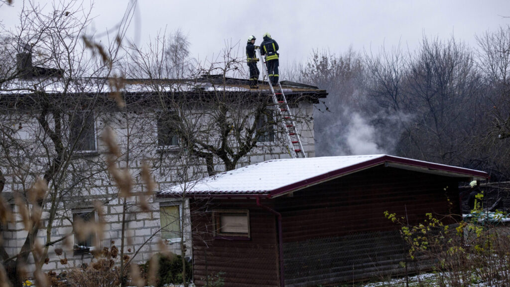 Lithuanian Emergency Ministry employees work near the place where a DHL cargo plane crashed into a house near the Lithuanian capital Vilnius, Lithuania, Lithuania, Monday, Nov. 25, 2024. (AP Photo/Mindaugas Kulbis) XAZ110