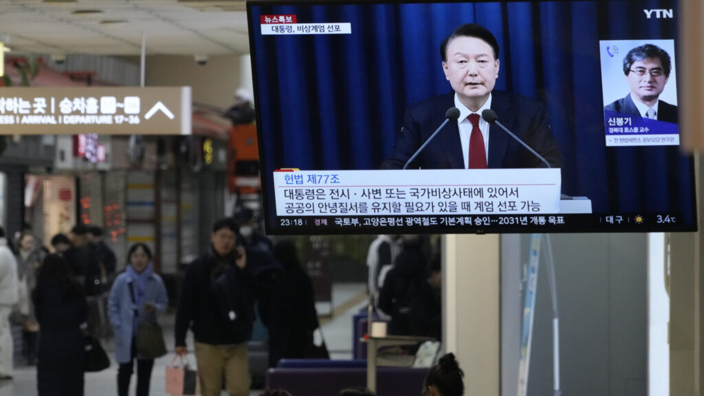 A TV screen shows South Korean President Yoon Suk Yeol's televised briefing at a bus terminal in Seoul, South Korea, Tuesday, Dec. 3, 2024. (AP Photo/Ahn Young-joon) SEL108