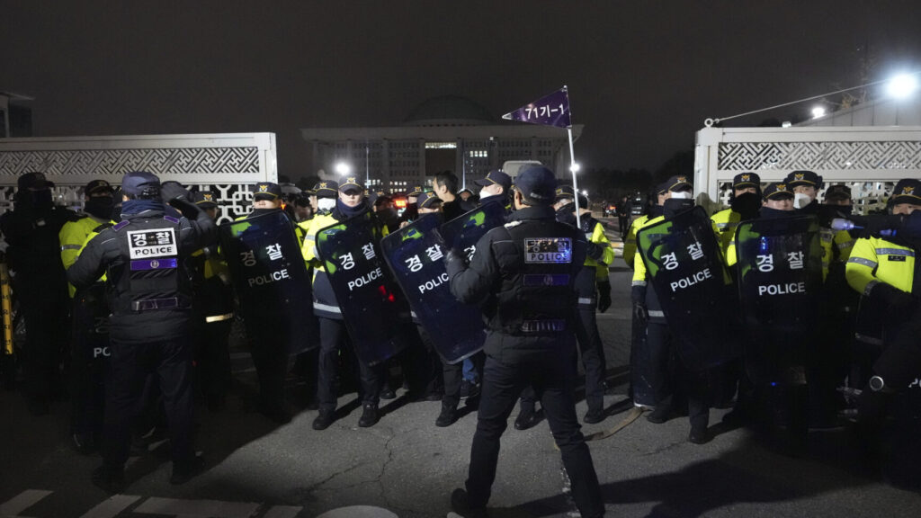 Police officers stand guard in front of the National Assembly in Seoul, South Korea, Tuesday, Dec. 3, 2024. (AP Photo/Lee Jin-man) LJM101