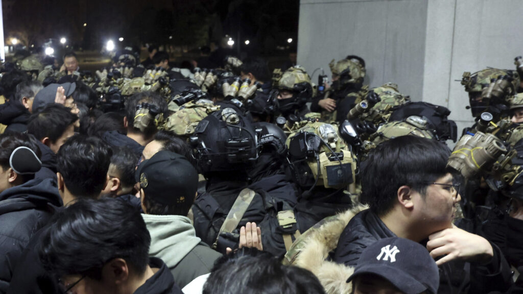 South Korean martial law soldiers try to enter the National Assembly compound in Seoul, South Korea, Wednesday, Dec. 4, 2024. (Cho Sung-bong/Newsis via AP) SEL802
