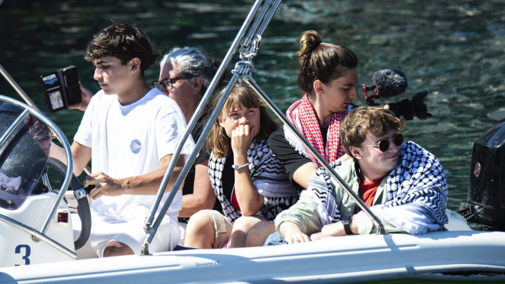 Climate activist Greta Thunberg, center, waits to board the Madleen boat, before setting sail for Gaza along with activists of the Freedom Flotilla Coalition, departing from the Sicilian port of Catania, Italy, Sunday, June 1, 2025. (AP Photo/Salvatore Cavalli) XSC110