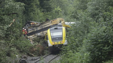 Rescue workers search for passengers in a derailed train, Zwiefaltendorf, Sunday July 27, 2025. (Thomas Warnack/dpa via AP)  lbj122