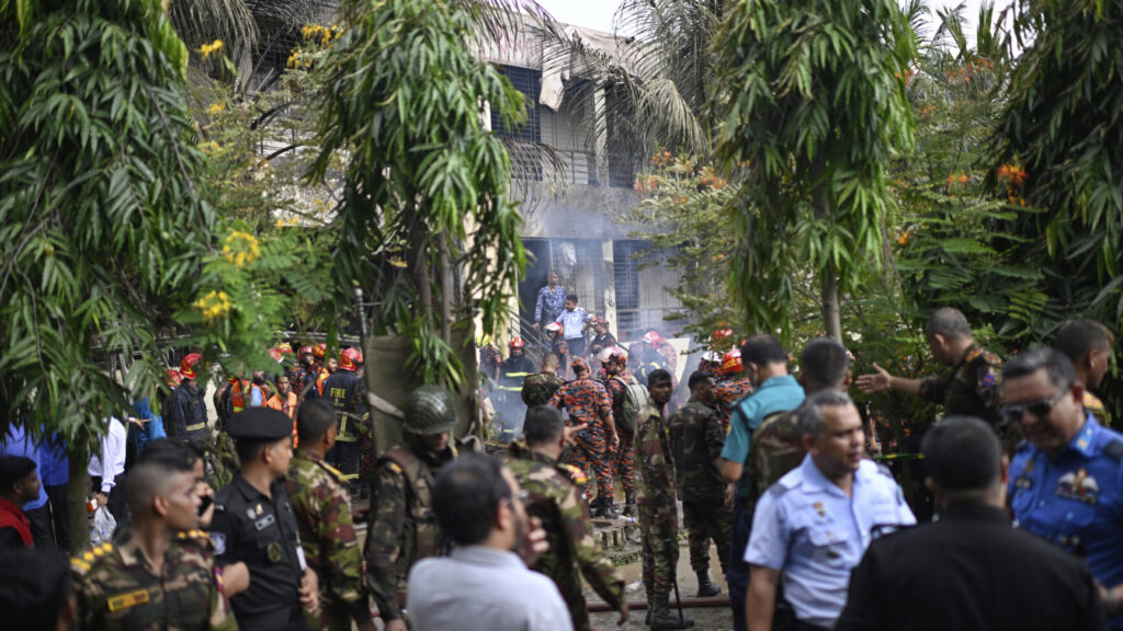 Firemen and security personnel look for the survivors after a Bangladesh Air Force training aircraft crashed into a school campus shortly after takeoff in Dhaka, Bangladesh, Monday, July 21, 2025. (AP Photo/Mahmud Hossain Opu) OPU108