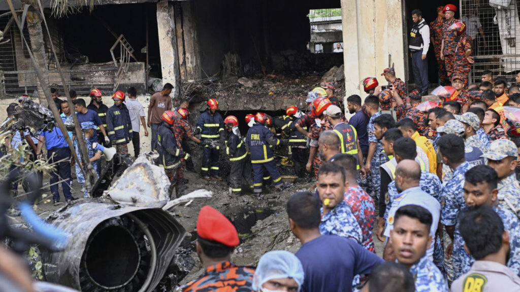 Firemen look for the survivors after a Bangladesh Air Force training aircraft that crashed onto a school campus shortly after takeoff in Dhaka, Bangladesh, Monday, July 21, 2025. (AP Photo/Mahmud Hossain Opu) OPU103