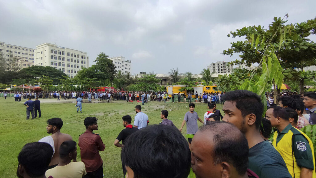 Volunteers cordon off the area after a Bangladesh Air Force training aircraft has crashed onto a school campus in Dhaka, Bangladesh, Monday, July 21, 2025. (AP Photo/Mahmud Hossain Opu) DHA101