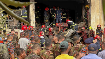 Firemen check the wreckage of a Bangladesh Air Force training aircraft that crashed onto a school campus in Dhaka, Bangladesh, Monday, July 21, 2025. (AP Photo/Al-emrun Garjon) GAR101