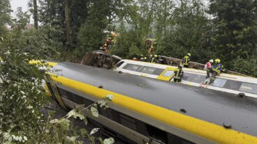 Rescue workers search for passengers in a derailed train, Zwiefaltendorf, Sunday July 27, 2025. (Thomas Warnack/dpa via AP)  lbj123
