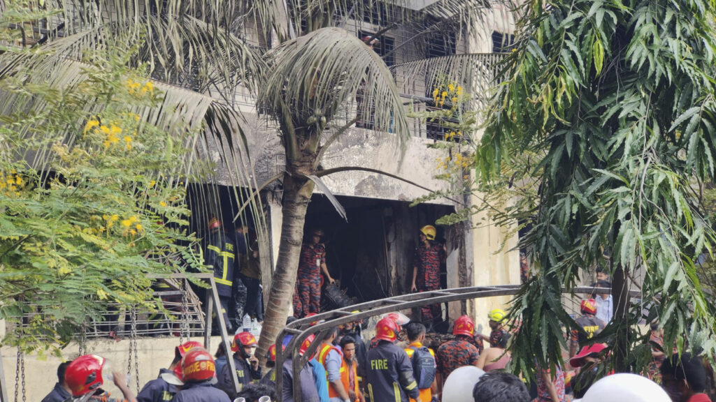 Firemen check the wreckage of a Bangladesh Air Force training aircraft that crashed onto a school campus in Dhaka, Bangladesh, Monday, July 21, 2025. (AP Photo/Mahmud Hossain Opu) OPU101