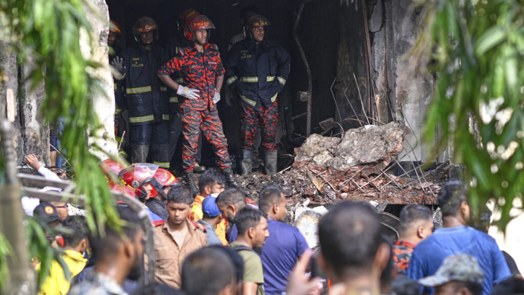 Firemen look for the survivors after a Bangladesh Air Force training aircraft that crashed onto a school campus shortly after takeoff in Dhaka, Bangladesh, Monday, July 21, 2025. (AP Photo/Mahmud Hossain Opu) OPU105