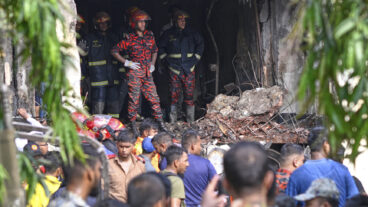 Firemen look for the survivors after a Bangladesh Air Force training aircraft that crashed onto a school campus shortly after takeoff in Dhaka, Bangladesh, Monday, July 21, 2025. (AP Photo/Mahmud Hossain Opu) OPU105