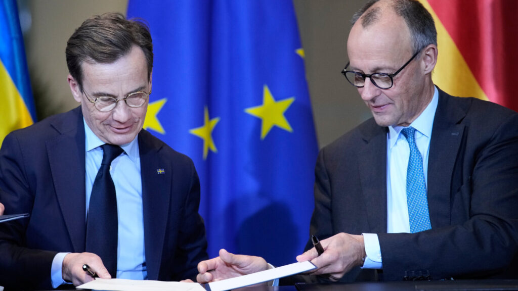 German Chancellor Friedrich Merz, right, and the Prime Minister from Sweden Ulf Kristersson, sign a German-Swedish Innovation Partnership in Berlin, Germany, Wednesday, Nov. 19, 2025. (AP Photo/Ebrahim Noroozi) PENO106