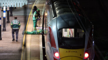 Emergency personnel inspect a train at the Huntingdon, England, train station in Cambridgeshire after people were stabbed Saturday, Nov. 1, 2025. (Chris Radburn/PA via AP)  uklpa606
