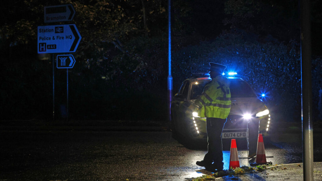 Police stand guard near the Huntingdon, England, train station in Cambridgeshire, after people were stabbed on a train, Saturday, Nov. 1, 2025. (Chris Radburn/PA via AP) uklpa604
