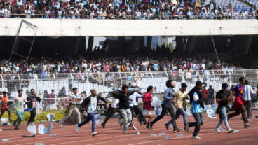 Indian fans vandalize stadium chairs as they run on to the field after failing to get a glimpse of Argentine soccer star Lionel Messi at the Salt Lake Stadium, in Kolkata, India, Saturday, Dec. 13, 2025. (AP Photo/Bikas Das)  XBD108