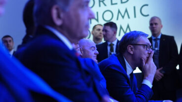 Audience members listen to the address of President Donald Trump during the Annual Meeting of the World Economic Forum in Davos, Switzerland, Wednesday, Jan. 21, 2026. (AP Photo/Evan Vucci) XVM139