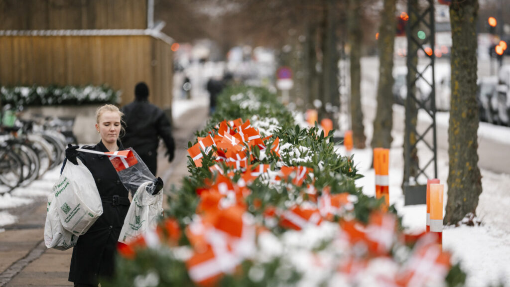 Maja Schlein Staal places Danish flags in front of the American embassy in Copenhagen on Wednesday, January 28, 2026. The flags are being placed in response to US President Donald Trump saying in an interview last Thursday that NATO soldiers in Afghanistan "stayed back a little, a little away from the front line." Maja Schlein Staal has herself been deployed to Denmark.