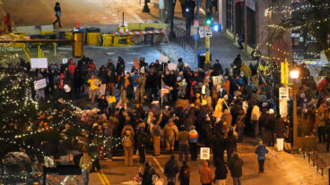 People gather during a vigil for 37-year-old Alex Pretti, who was fatally shot by a U.S. Border Patrol officer earlier in the day, Saturday, Jan. 24, 2026, in Minneapolis. (AP Photo/Adam Gray)  MNSS625