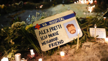 A sign for 37-year-old Alex Pretti, who was fatally shot by a U.S. Border Patrol officer earlier in the day, is displayed during a vigil Saturday, Jan. 24, 2026, in Minneapolis. (AP Photo/Adam Gray)  MNSS620
