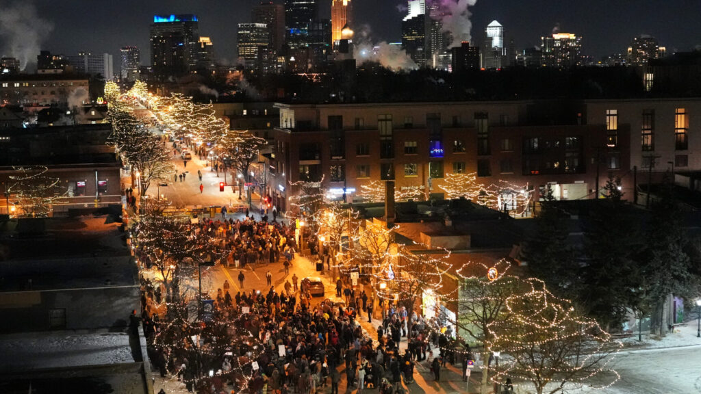 People gather during a vigil for 37-year-old Alex Pretti, who was fatally shot by a U.S. Border Patrol officer earlier in the day, Saturday, Jan. 24, 2026, in Minneapolis. (AP Photo/Adam Gray) MNSS626