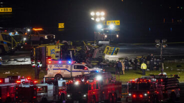 A Port Authority aircraft rescue and firefighting vehicle lays on its side off of runway 4 after colliding with an Air Canada Jet after it landed at LaGuardia Airport, Monday, March 23, 2026, in New York. (AP Photo/Ryan Murphy)  NYJJ108
