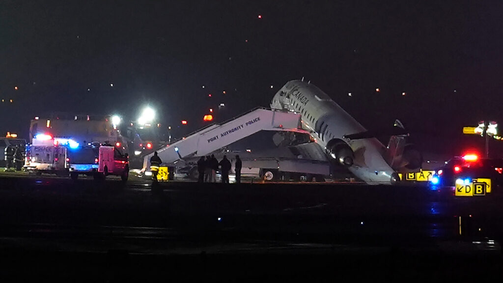 An Air Canada Jet sits on the runway at LaGuardia Airport, Monday, March 23, 2026, after colliding with a Port Authority vehicle in New York. (AP Photo/Ryan Murphy) NYJJ101