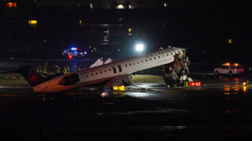 An Air Canada Jet sits on the runway at LaGuardia Airport, Monday, March 23, 2026, after colliding with a Port Authority aircraft rescue and firefighting vehicle in New York. (AP Photo/Ryan Murphy)  NYJJ106
