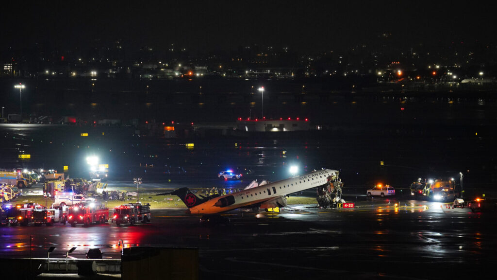 An Air Canada Jet sits on the runway at LaGuardia Airport, Monday, March 23, 2026, after colliding with a Port Authority aircraft rescue and firefighting vehicle in New York. (AP Photo/Ryan Murphy) NYJJ107