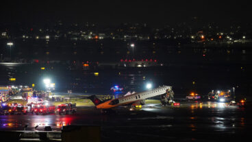 An Air Canada Jet sits on the runway at LaGuardia Airport, Monday, March 23, 2026, after colliding with a Port Authority aircraft rescue and firefighting vehicle in New York. (AP Photo/Ryan Murphy)  NYJJ107