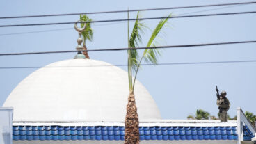 Police stage on a roof at the scene of a shooting outside the Islamic Center of San Diego Monday, May 18, 2026, in San Diego. (AP Photo/Gregory Bull)  LA116