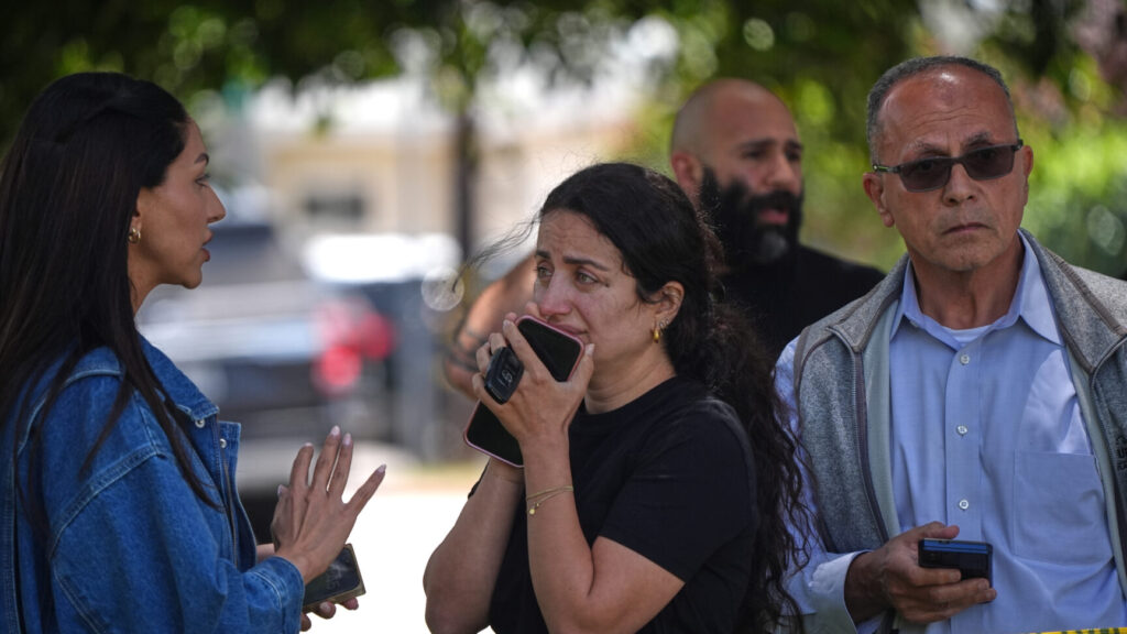 People stand behind police tape at the scene of a shooting outside the Islamic Center of San Diego Monday, May 18, 2026, in San Diego. (AP Photo/Gregory Bull) LA109