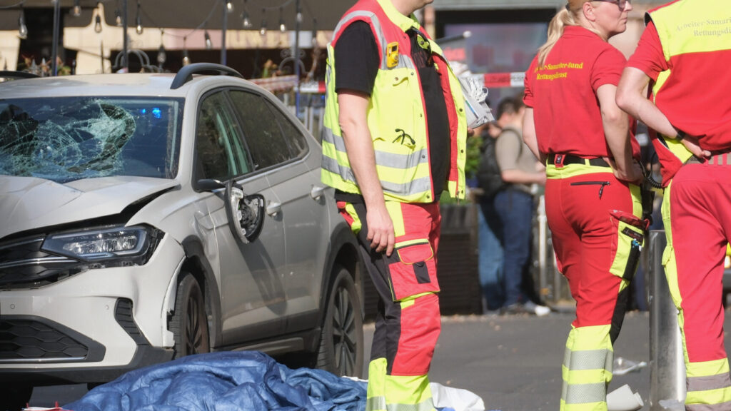 Rescue workers stand next to a damaged car that has crashed into several people in Leipzig, Germany, Monday, May 4, 2026. (Sebastian Willnow/dpa via AP) DSOB106
