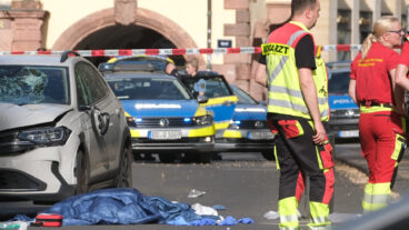 Rescue workers stand next to a damaged car that has crashed into several people in Leipzig, Germany, Monday, May 4, 2026. (Sebastian Willnow/dpa via AP)  DSOB103