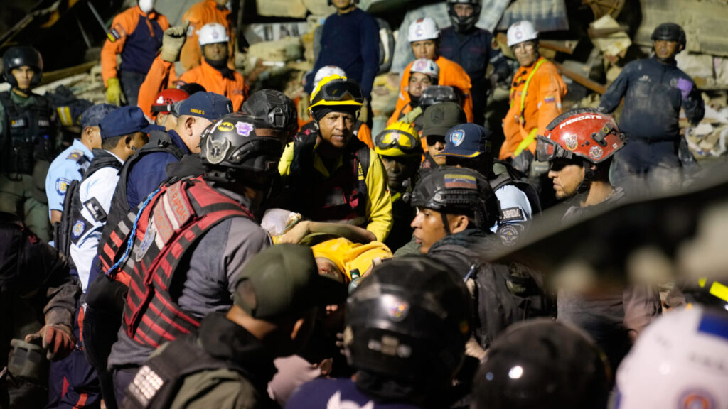 Rescue workers search through the rubble of a collapsed building after earthquake in Caracas, Venezuela, Wednesday, June 24, 2026. (AP Photo/Ariana Cubillos) XRM511