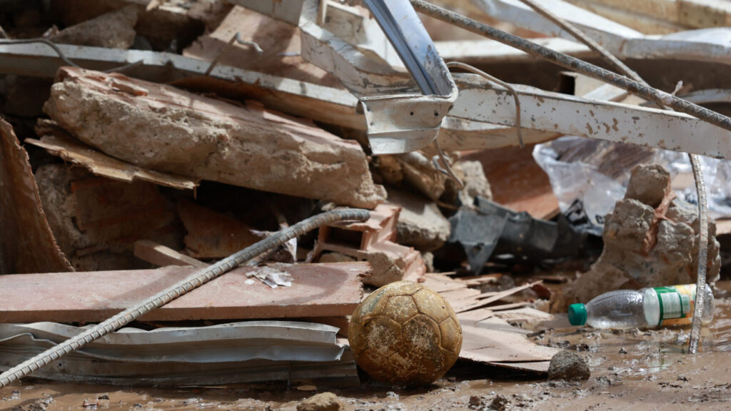 A soccer ball lies amid the rubble in La Guaira, Venezuela, three days after twin earthquakes struck, Saturday, June 27, 2026. (AP Photo/Javier Campos) XRM741