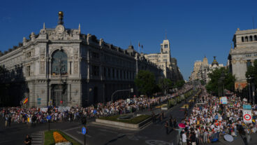 People wait for the arrival of Pope Leo XIV ahead of a Holy Mass and Corpus Christi procession at Plaza de Cibeles in Madrid, Spain, Sunday, June 7, 2026, on the second day of his seven-day apostolic visit to mainland Spain and the Canary Islands. (AP Photo/Manu Fernandez) EM120