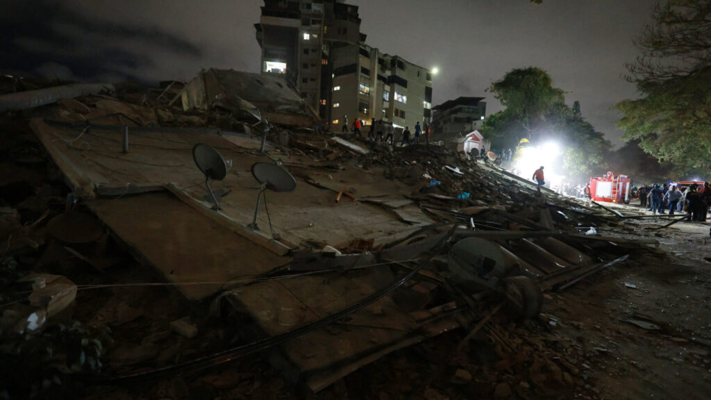 Rescue workers search through the rubble of a collapsed building after an earthquake in Caracas, Venezuela, Wednesday, June 24, 2026. (AP Photo/Javier Campos) XRM501