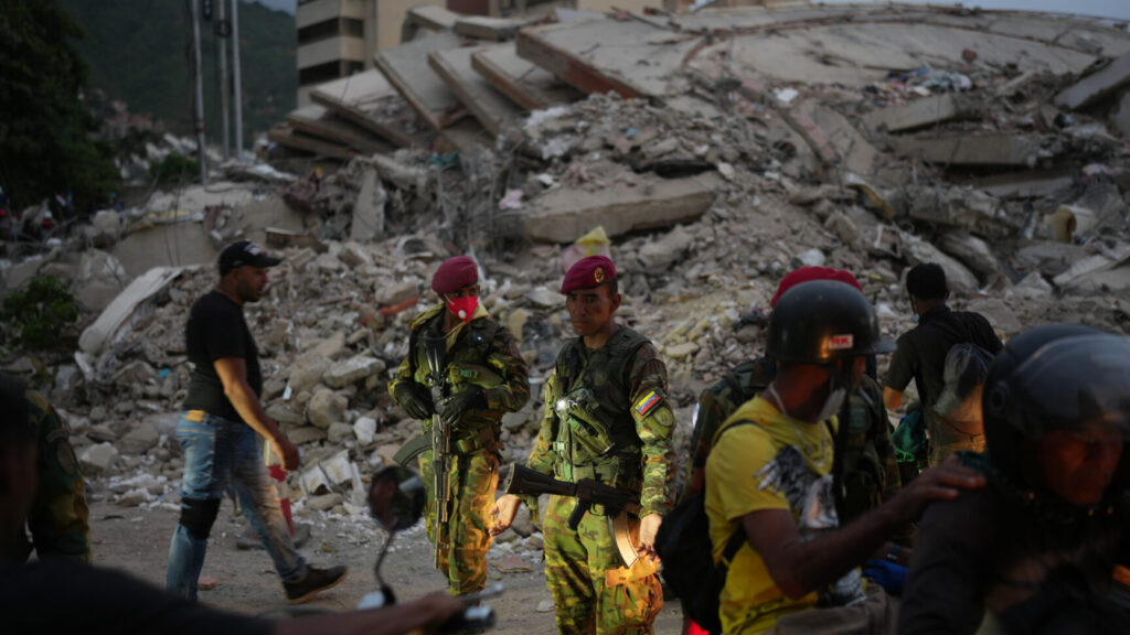 Soldiers guard an area damaged by the earthquakes in La Guaira, Venezuela, Saturday, June 27, 2026. (AP Photo/Matias Delacroix) XRM730