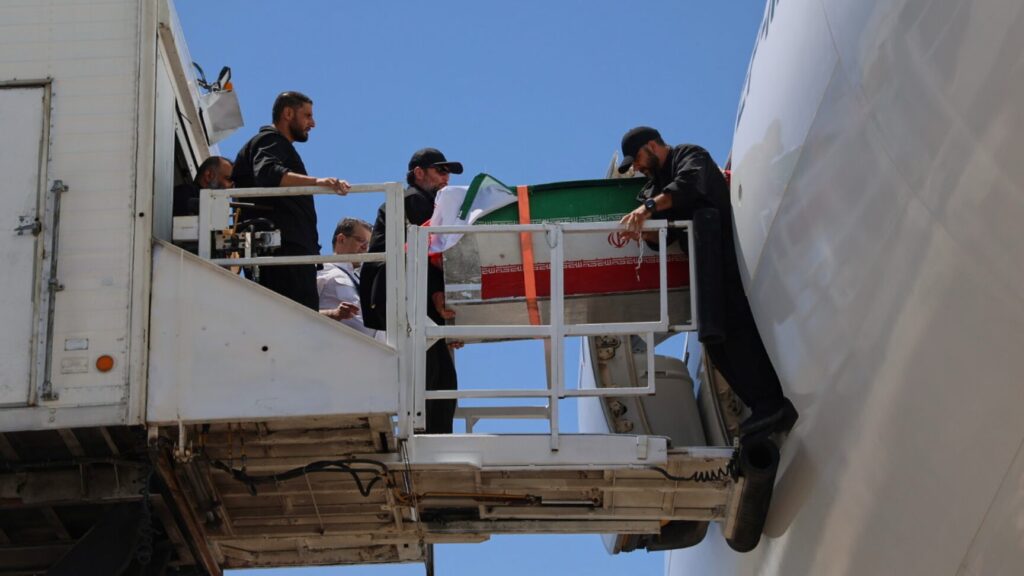 The coffin of the late Iranian Supreme Leader Ayatollah Ali Khamenei is carried from a plane at Hasheminejad International Airport after arriving from Iraq for the final stage of his dayslong funeral ceremonies in Mashhad, northeastern Iran, Thursday, July 9, 2026. (Mohammad Hasan Salavati/Shahraranews via AP) XEM139