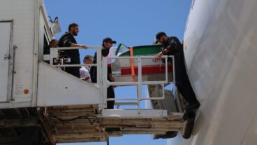 The coffin of the late Iranian Supreme Leader Ayatollah Ali Khamenei is carried from a plane at Hasheminejad International Airport after arriving from Iraq for the final stage of his dayslong funeral ceremonies in Mashhad, northeastern Iran, Thursday, July 9, 2026. (Mohammad Hasan Salavati/Shahraranews via AP)  XEM139