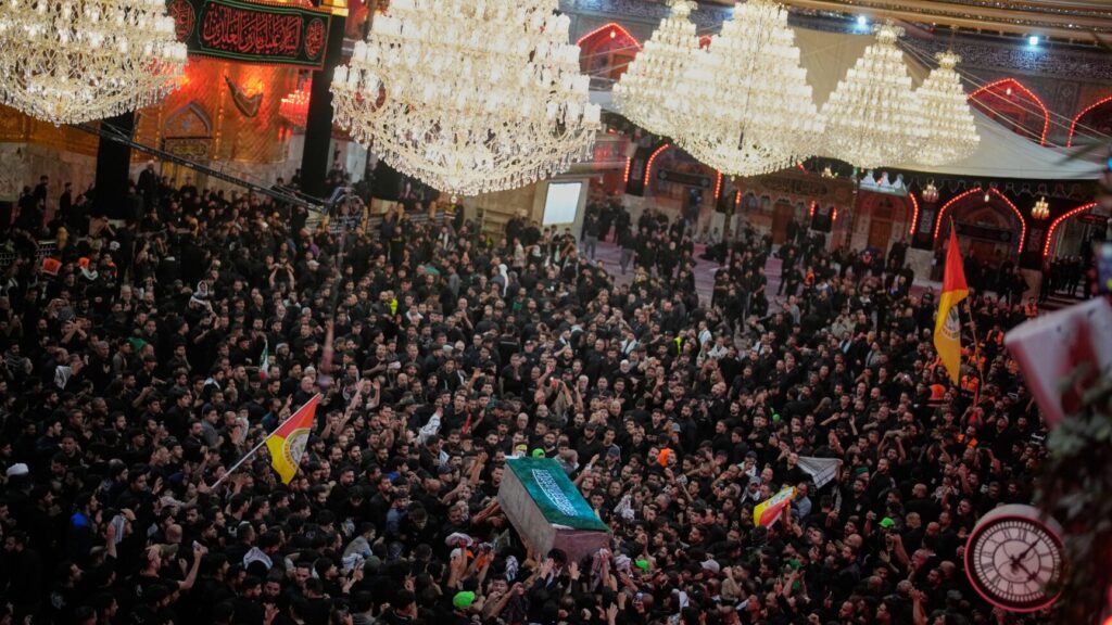 The coffin of the late Iranian Supreme Leader Ayatollah Ali Khamenei is carried through a crowd of mourners at the Imam Hussein Shrine in Karbala, Iraq, early Thursday, July 9, 2026. (AP Photo/Khalil Hamra) XEM131