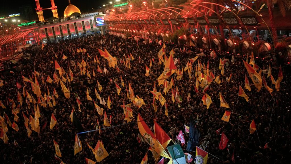 The coffin of the late Iranian Supreme Leader Ayatollah Ali Khamenei is carried surrounded by mourners outside the Imam Hussein Shrine in Karbala, Iraq, early Thursday July 9, 2026. (AP Photo/Khalil Hamra) XEM101