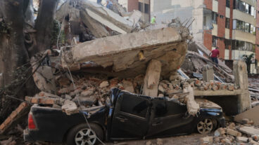 A vehicle is crushed by debris after an earthquake struck Cali, Colombia, Monday, Aug. 10, 2026. (AP Photo/Juan Diaz)  XRM869