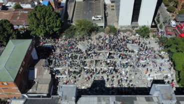 Residents and rescue workers search through the rubble after an earthquake struck Cali, Colombia, Monday, Aug. 10, 2026. (AP Photo/Santiago Saldarriaga)  XRM889